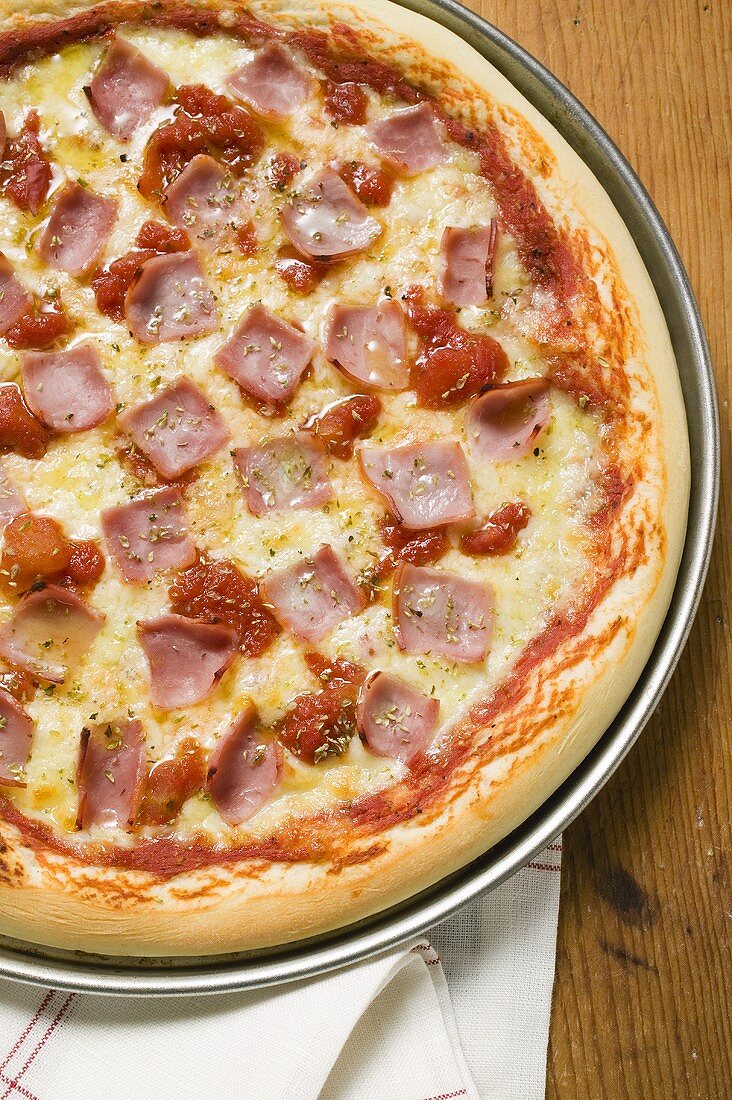 Ham, cheese and tomato pizza (detail)