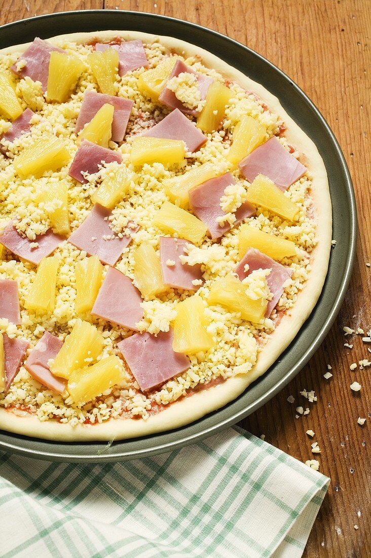 Hawaiian pizza with ham and pineapple (unbaked)