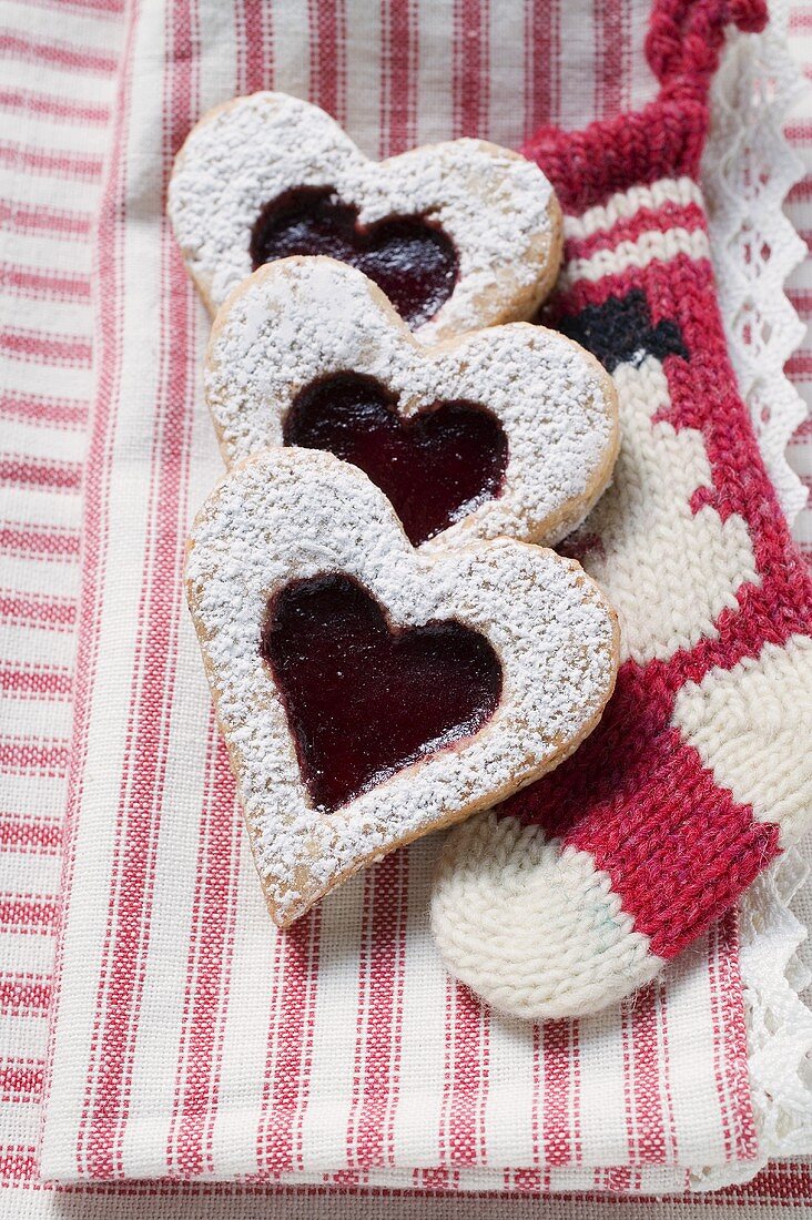 Heart-shaped biscuits with raspberry jam and icing sugar