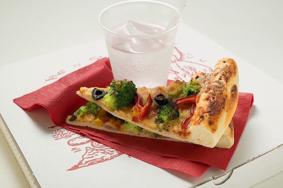 Two pieces of American-style vegetable pizza & mineral water