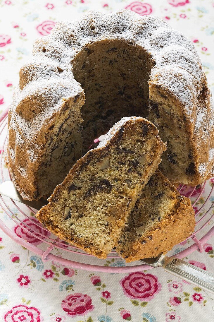 Marzipan gugelhupf with icing sugar, partly sliced