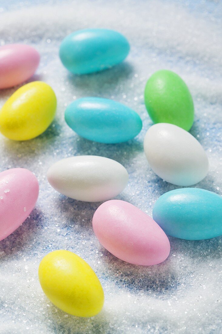 Coloured sugared almonds on sugar