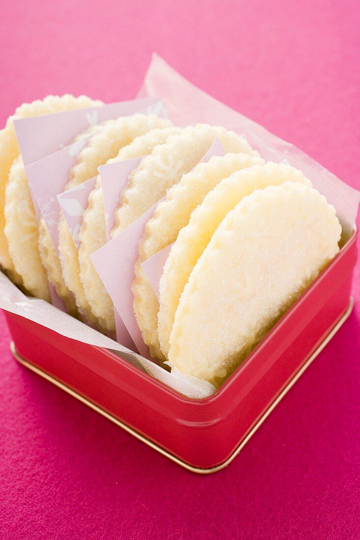 Christmas biscuits with icing stars in biscuit tin