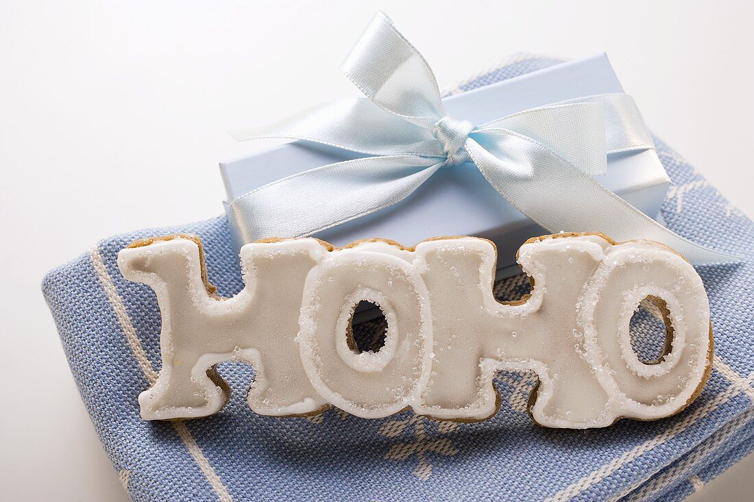 The word 'HOHO' in gingerbread with white icing, gift