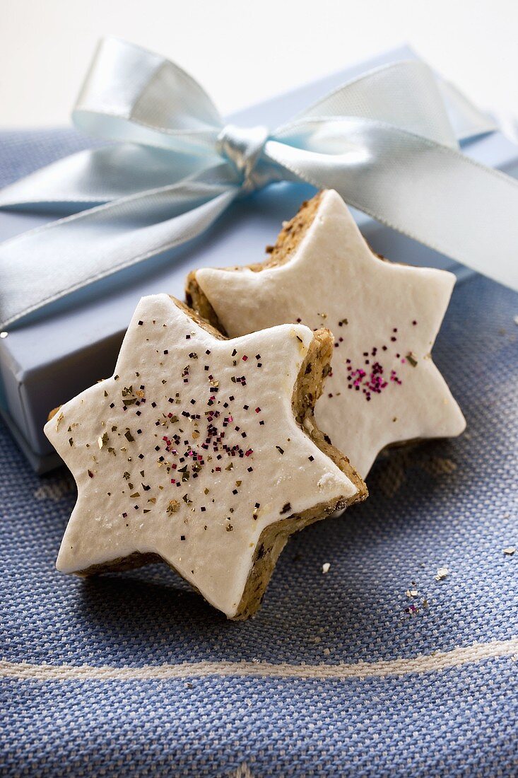 Cinnamon stars in front of Christmas gift