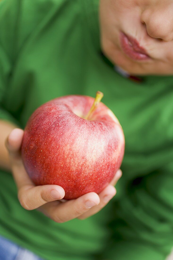 Child eating a Gala apple