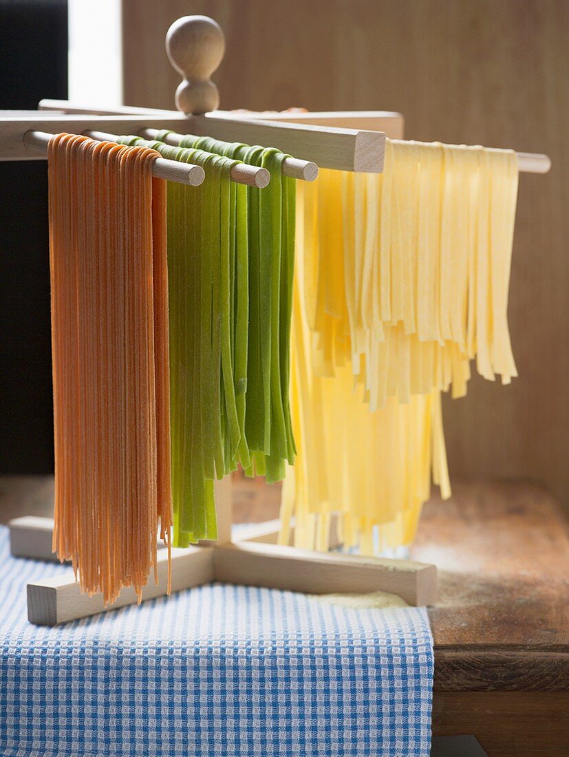 Home-made ribbon pasta hanging up to dry