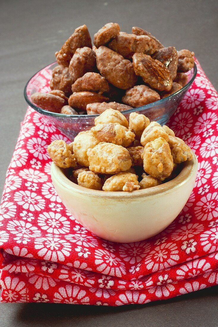 Assorted nuts to nibble in bowls on patterned cloth