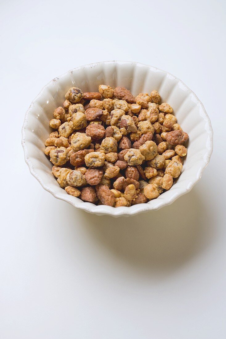 Mixed nuts to nibble in white bowl