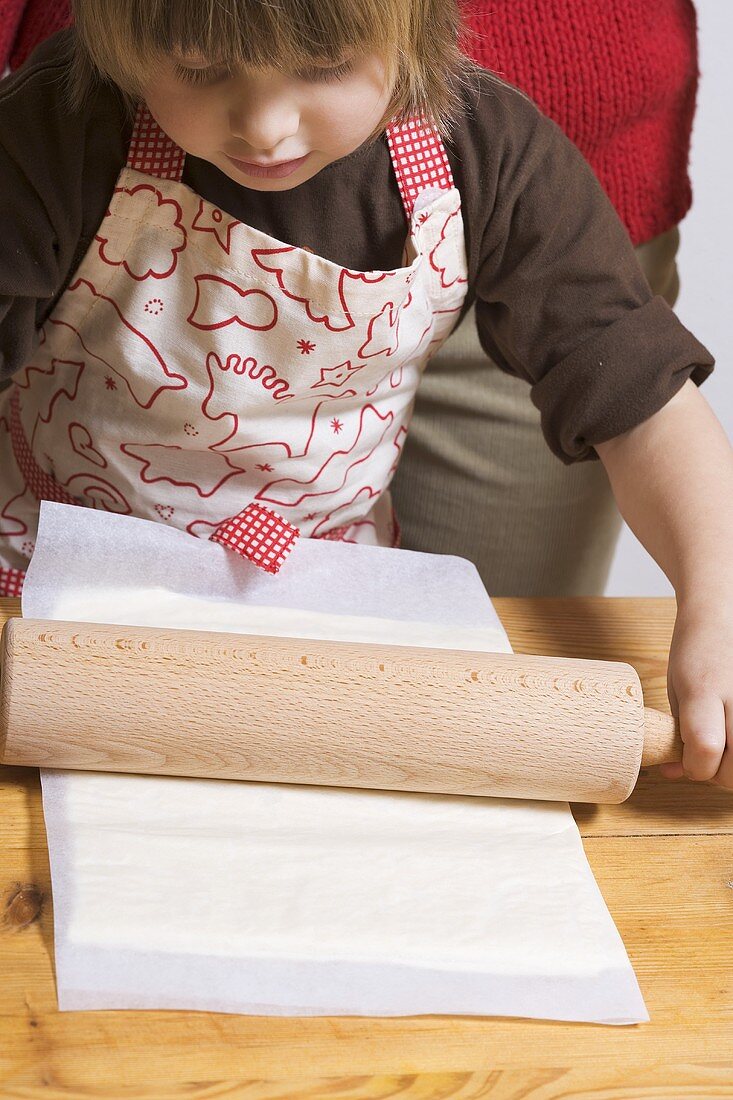 Mother and child rolling out puff pastry