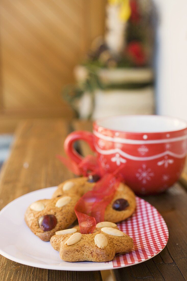 Assorted gingerbread on plate in front of large cup