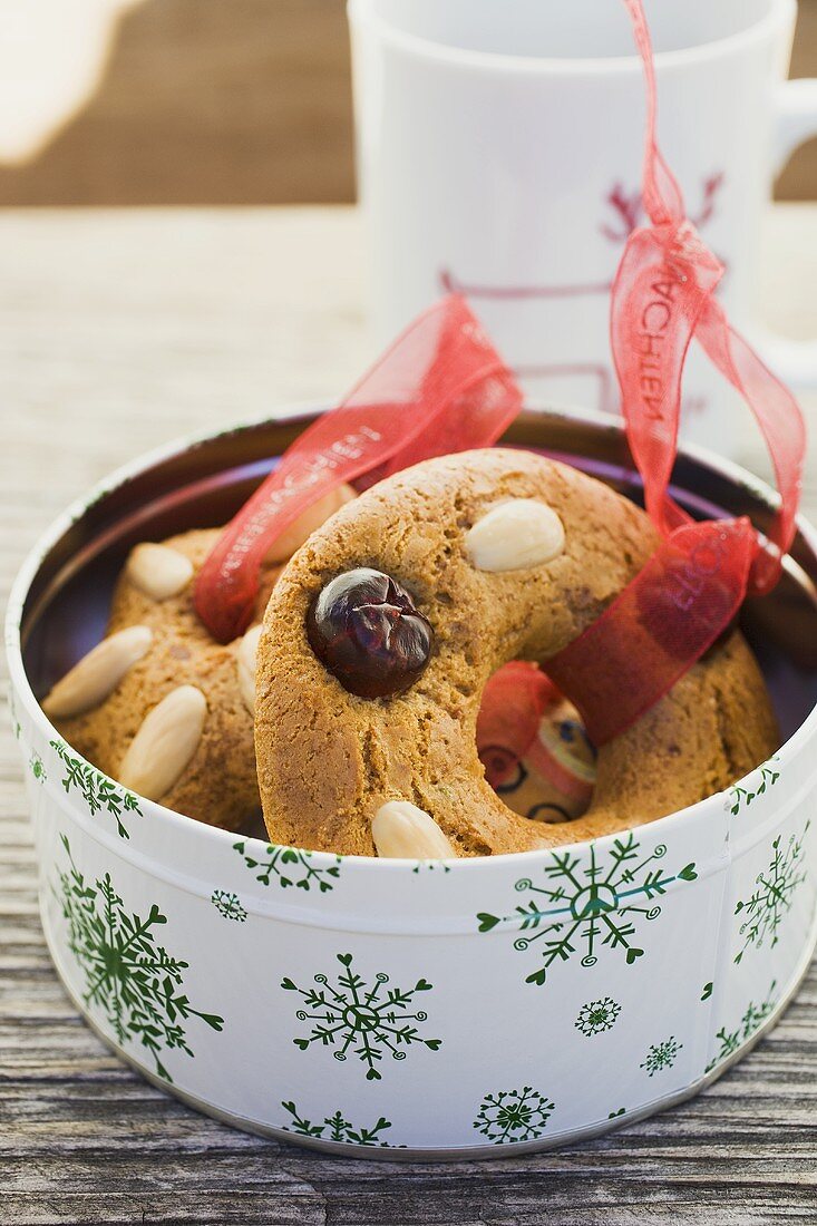 Assorted gingerbread tree ornaments in biscuit tin