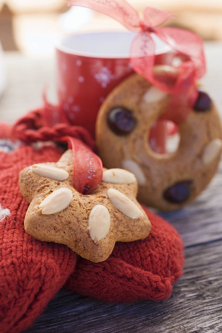Gingerbread tree ornaments, woollen mittens and cup