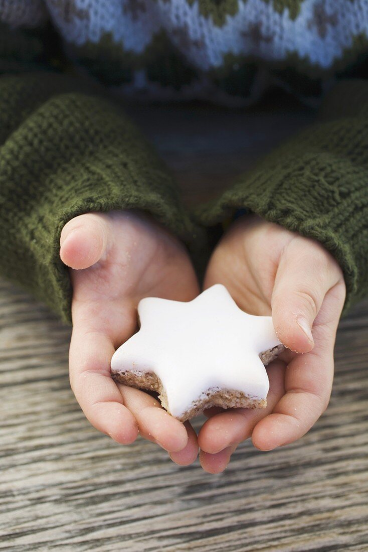 Child's hands holding cinnamon star