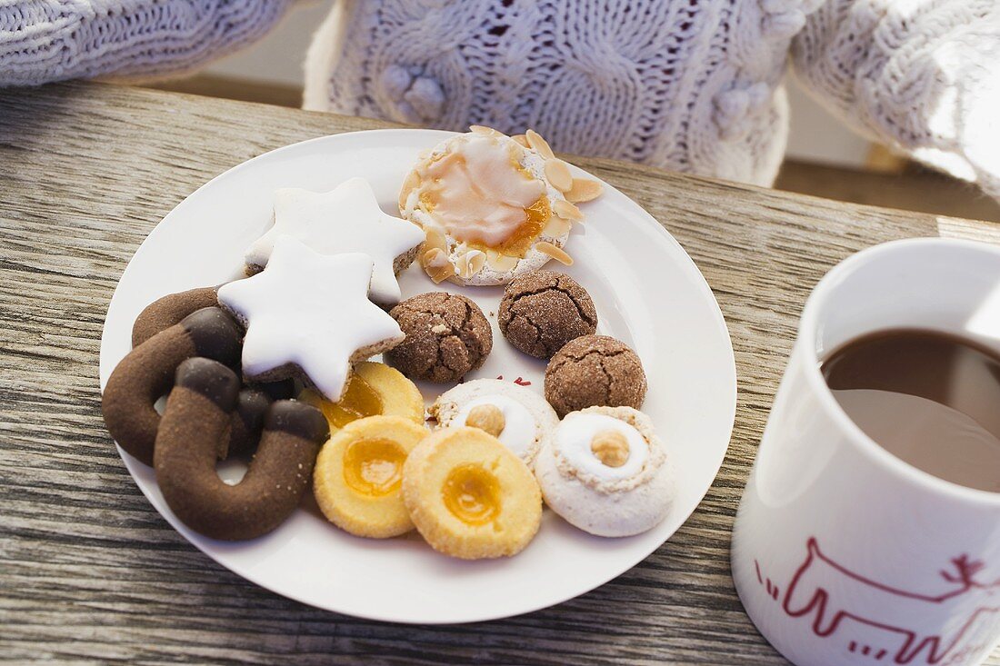 Plate of biscuits and cup of cocoa, child in background