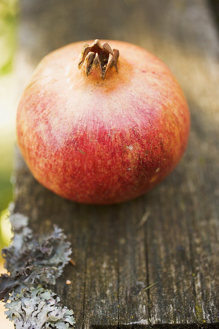 Pomegranate on old wooden board