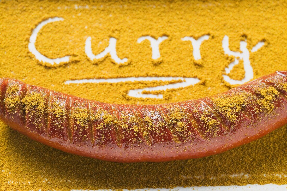 Currywurst and the word 'Curry' written in curry powder