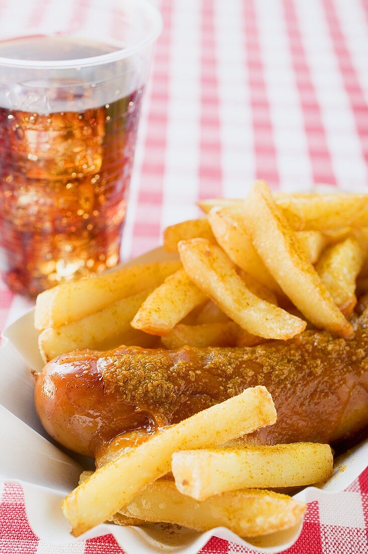 Currywurst (sausage with ketchup & curry powder) in paper dish, cola