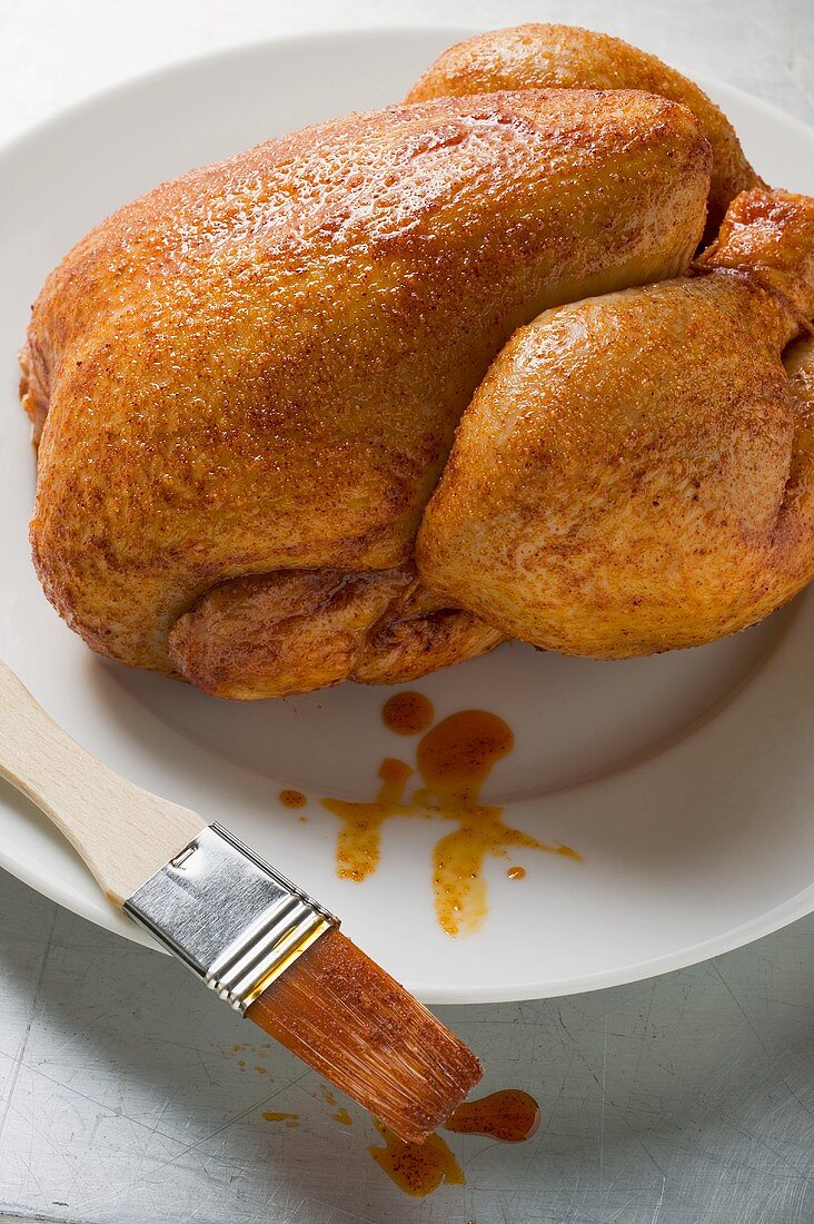 Fresh marinated chicken with basting brush