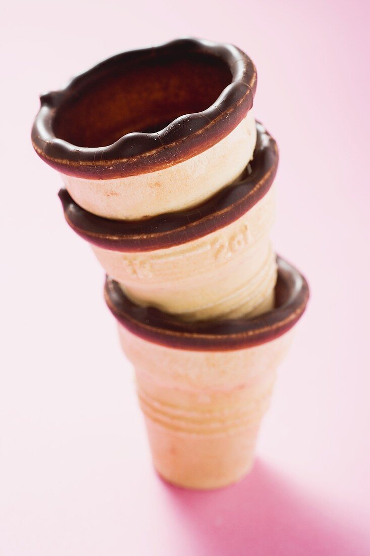 Empty chocolate-dipped ice cream cones, in a pile