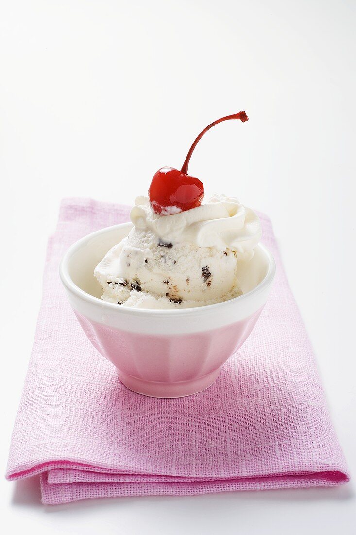 Stracciatella ice cream with cream and cherry
