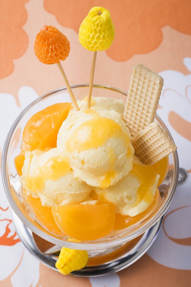 Fruity ice cream sundae with apricots (overhead view)