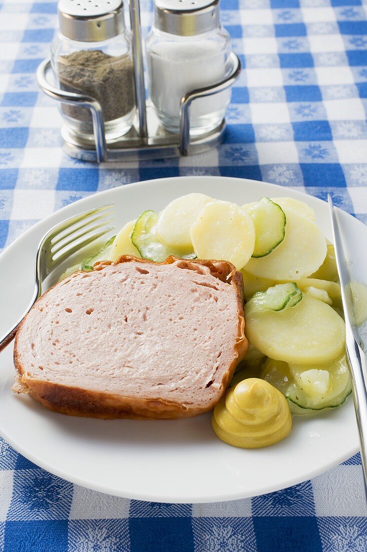Leberkäse (type of meatloaf) with mustard & potato salad on plate