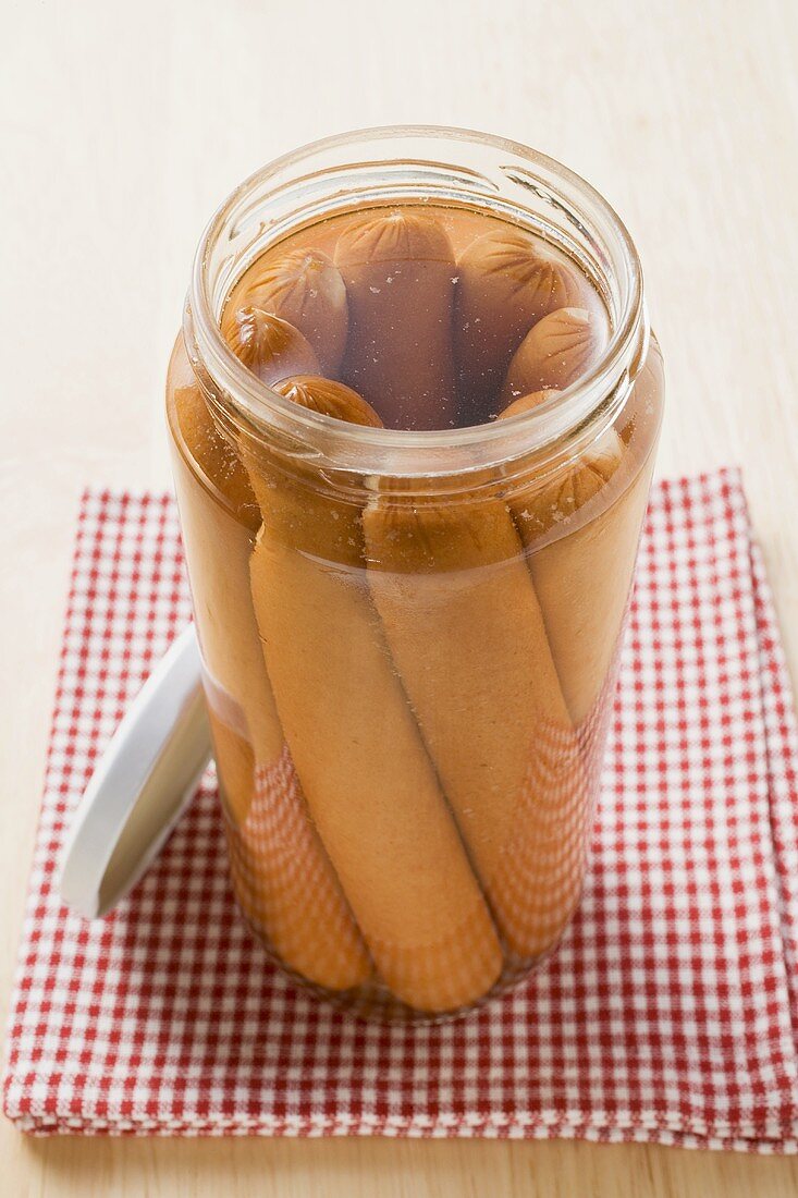 Frankfurters in an opened jar