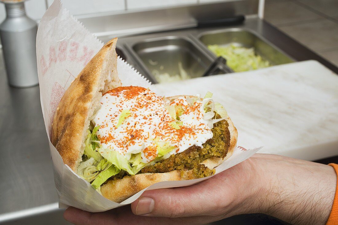 Pita bread filled with falafel, lettuce and yoghurt