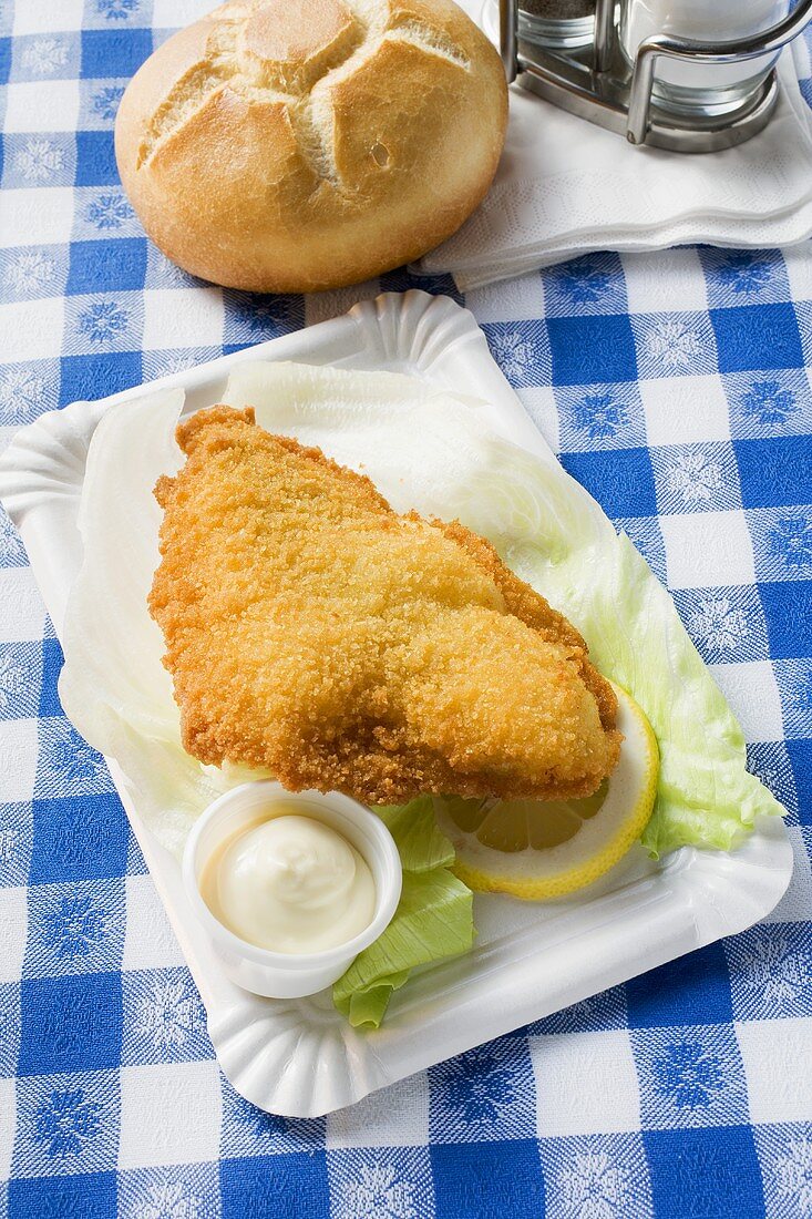 Fish fillet with mayonnaise and bread roll in snack bar