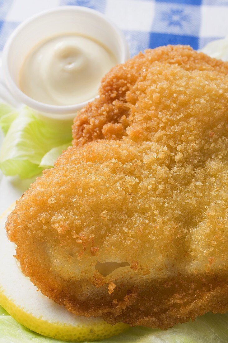 Breaded fish fillet with mayonnaise (close-up)