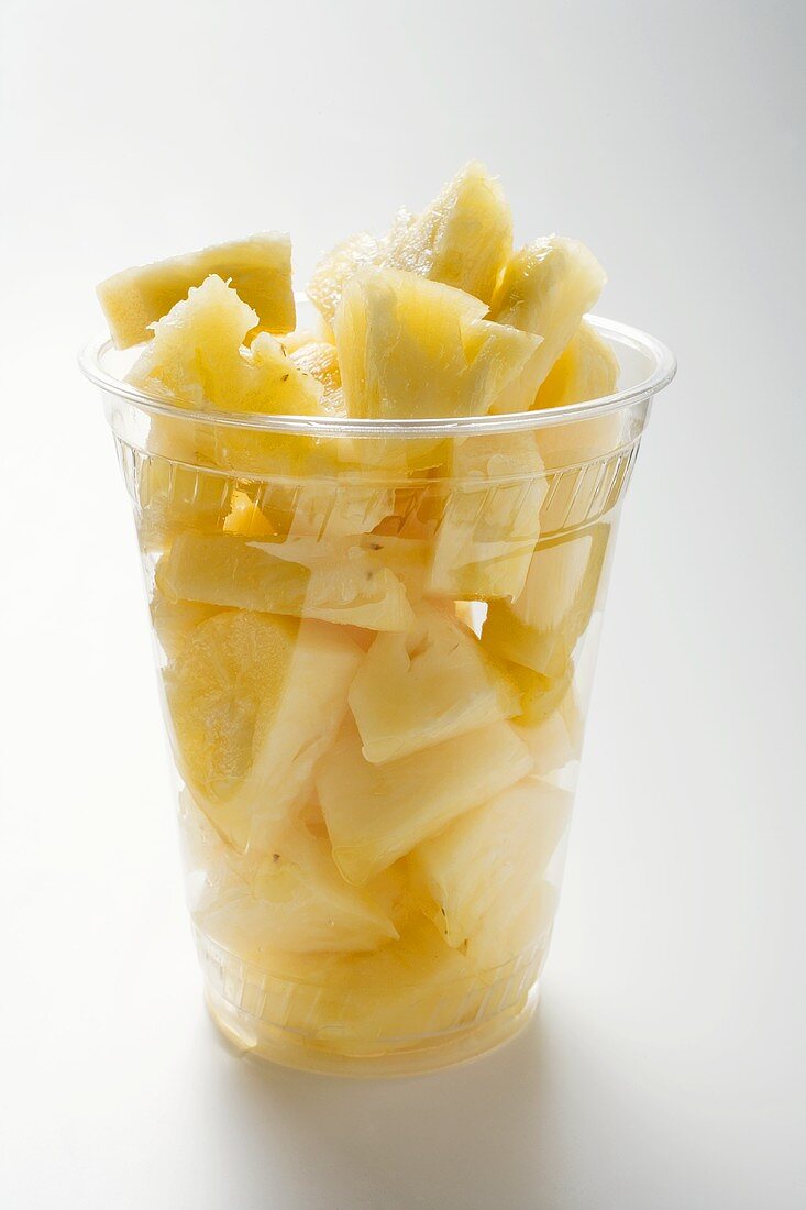 Pineapple chunks in a plastic beaker
