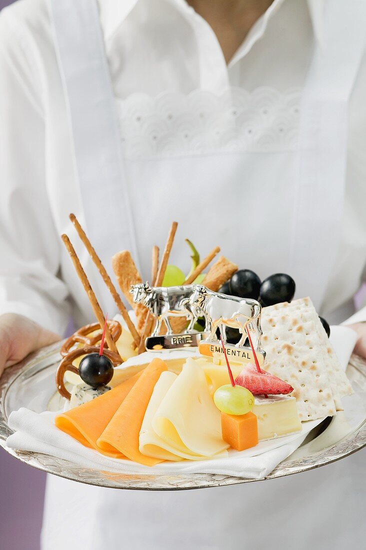 Waitress serving a cheese platter