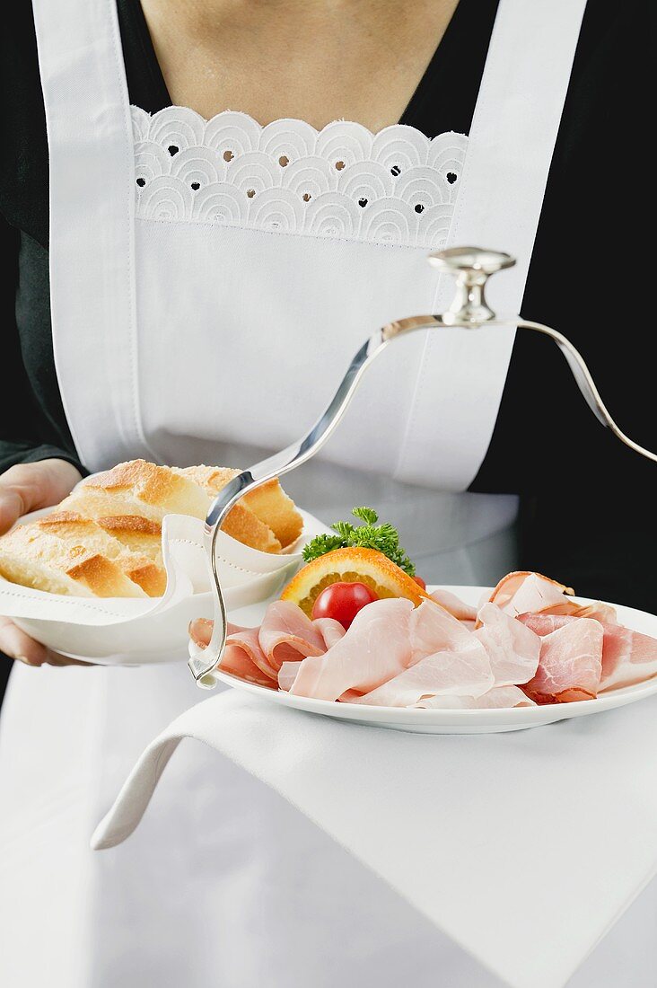 Waitress serving ham and white bread