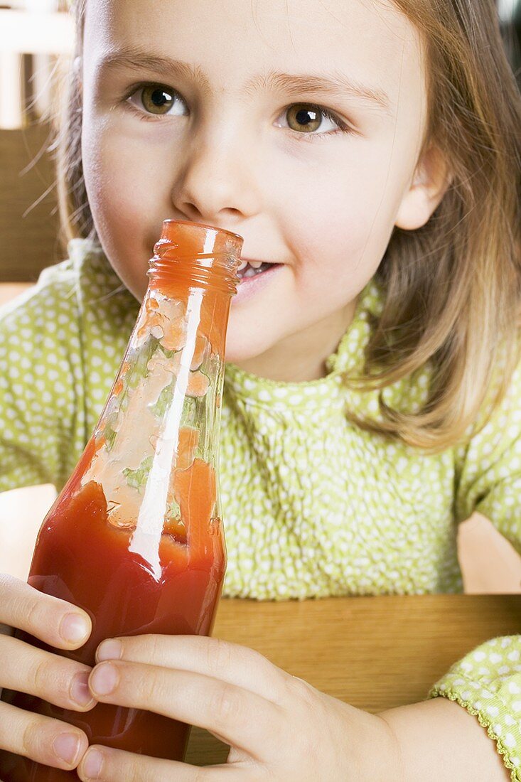 Girl holding a bottle of ketchup