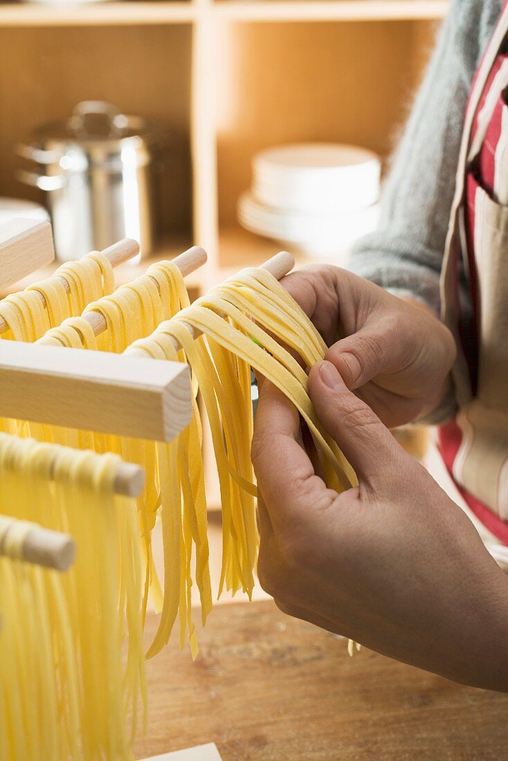 Hanging home-made ribbon pasta up to dry