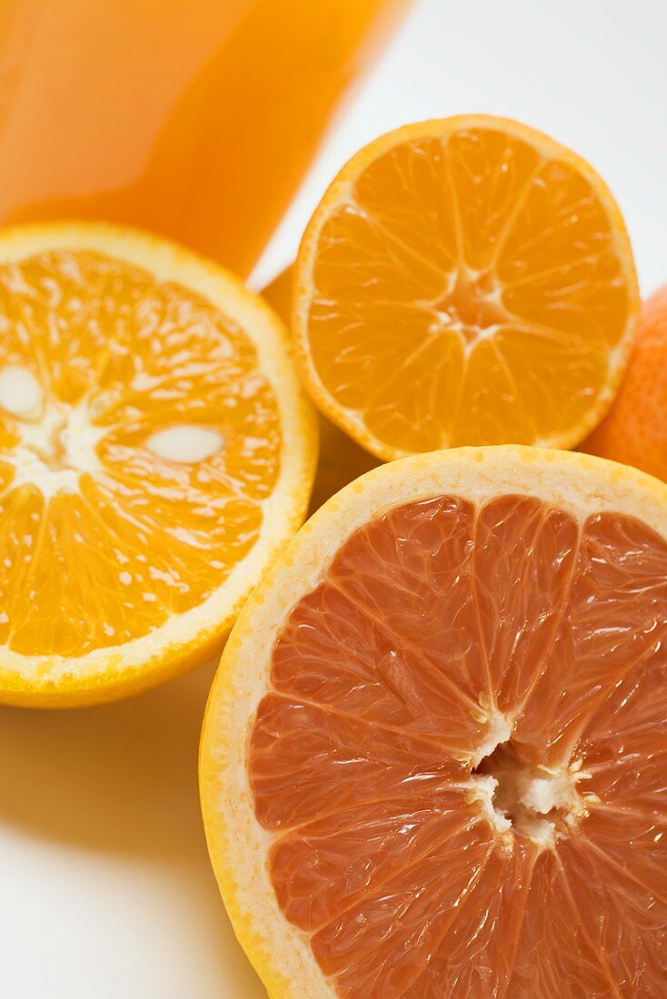 Glass of orange juice, grapefruit and oranges