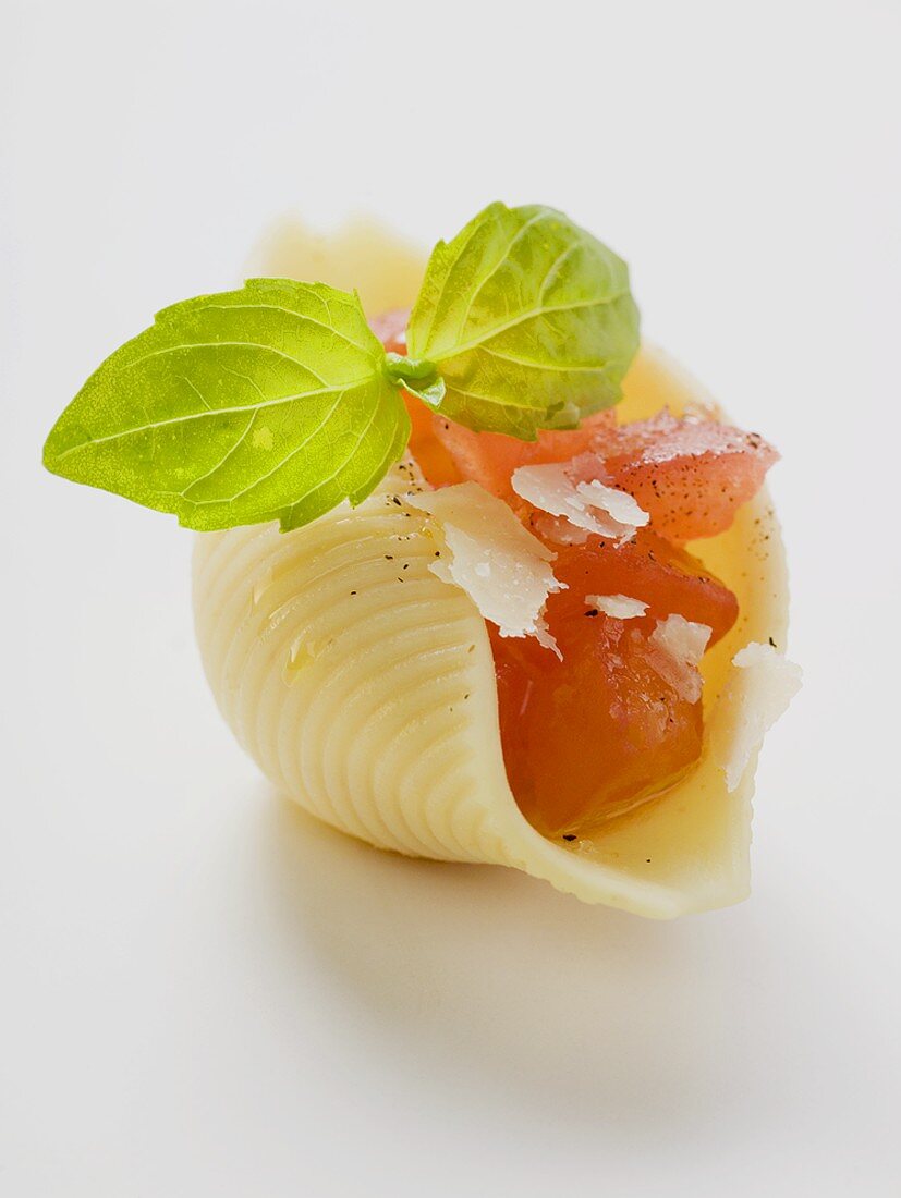 Pasta shell, filled with diced tomato