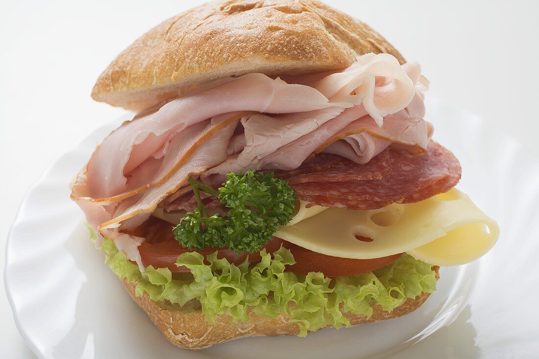 Bread roll filled with ham, salami and cheese