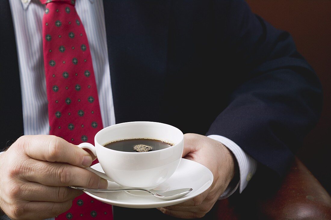 Man holding cup of coffee