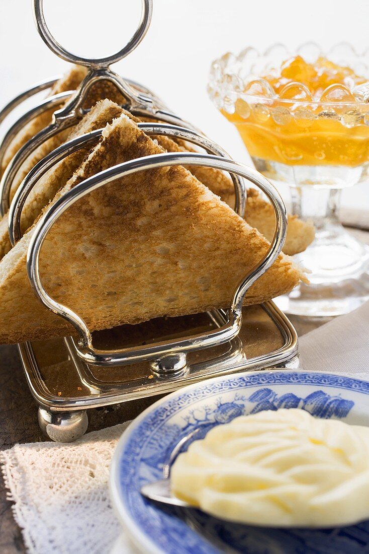 Toast in toast rack, butter, orange marmalade