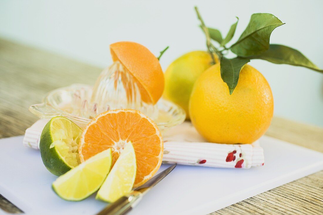Limes, clementine, oranges and citrus squeezer