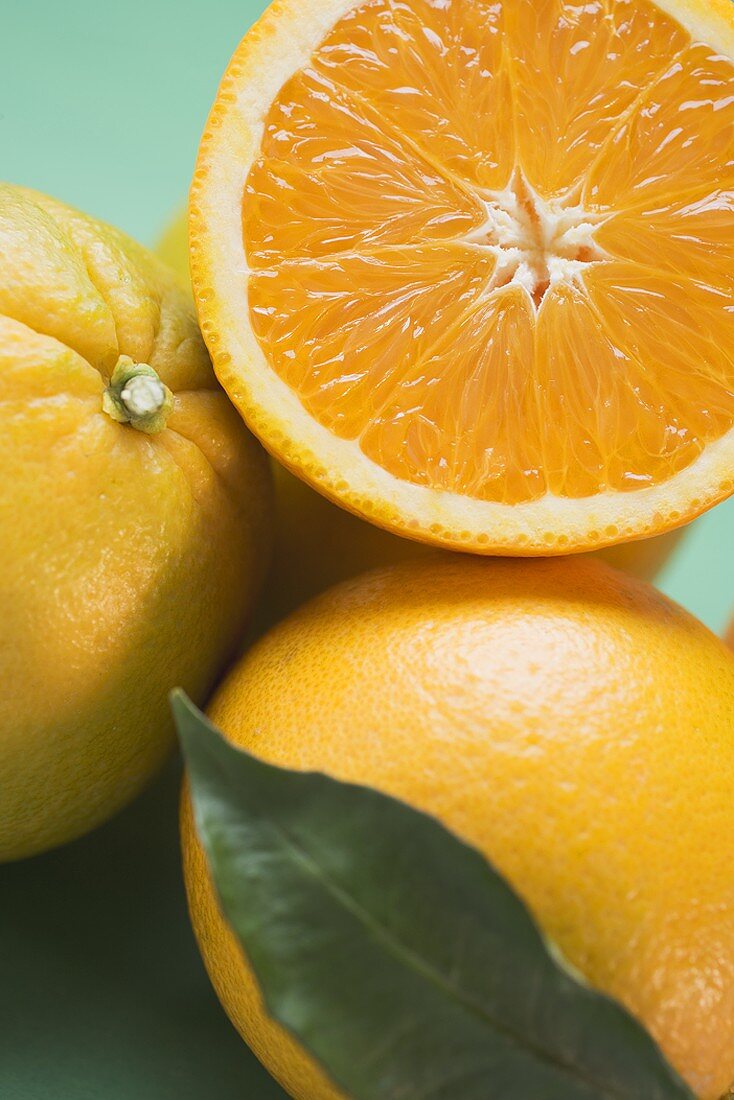 Oranges, whole and halved, with leaf