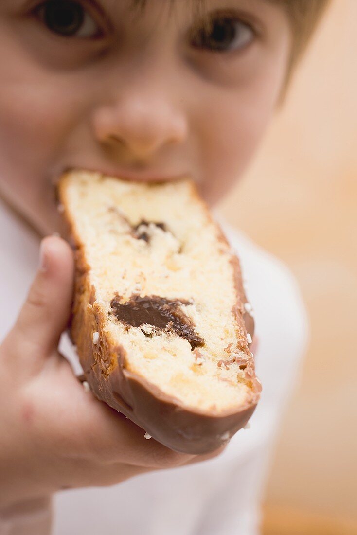 Child biting into a piece of Easter cake