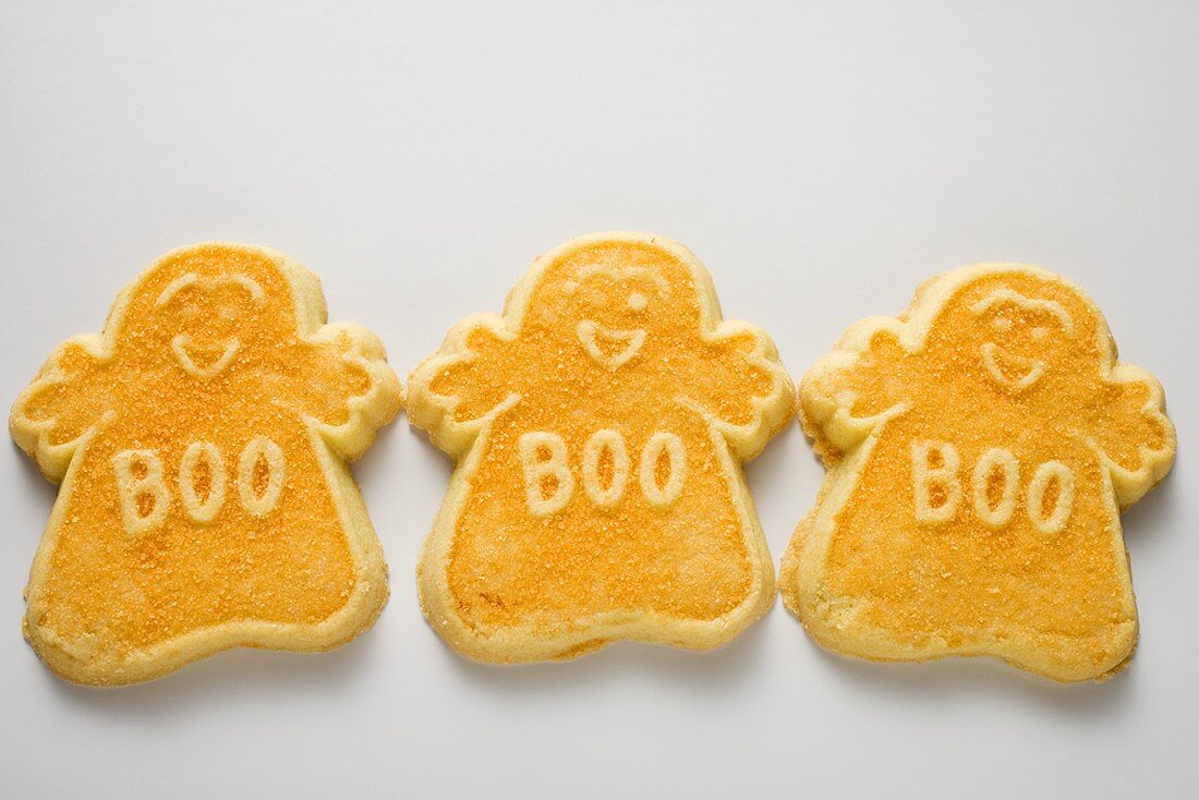Three orange ghost biscuits for Halloween