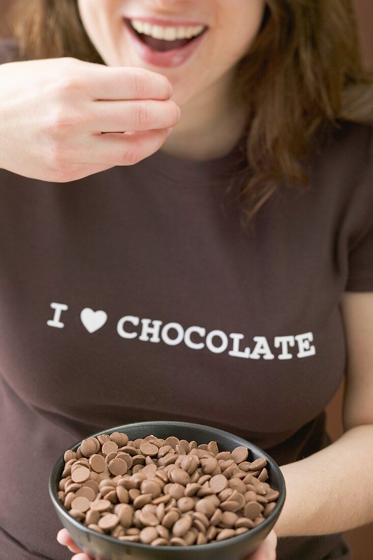 Woman eating chocolate chips