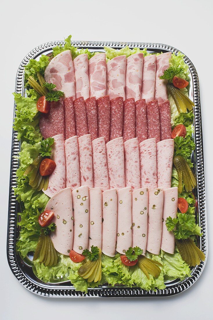 Cold cut platter garnished with gherkins (overhead view)