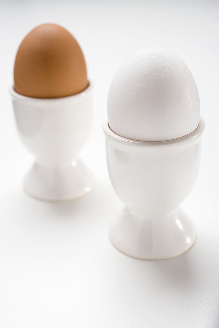 Brown and white eggs in eggcups