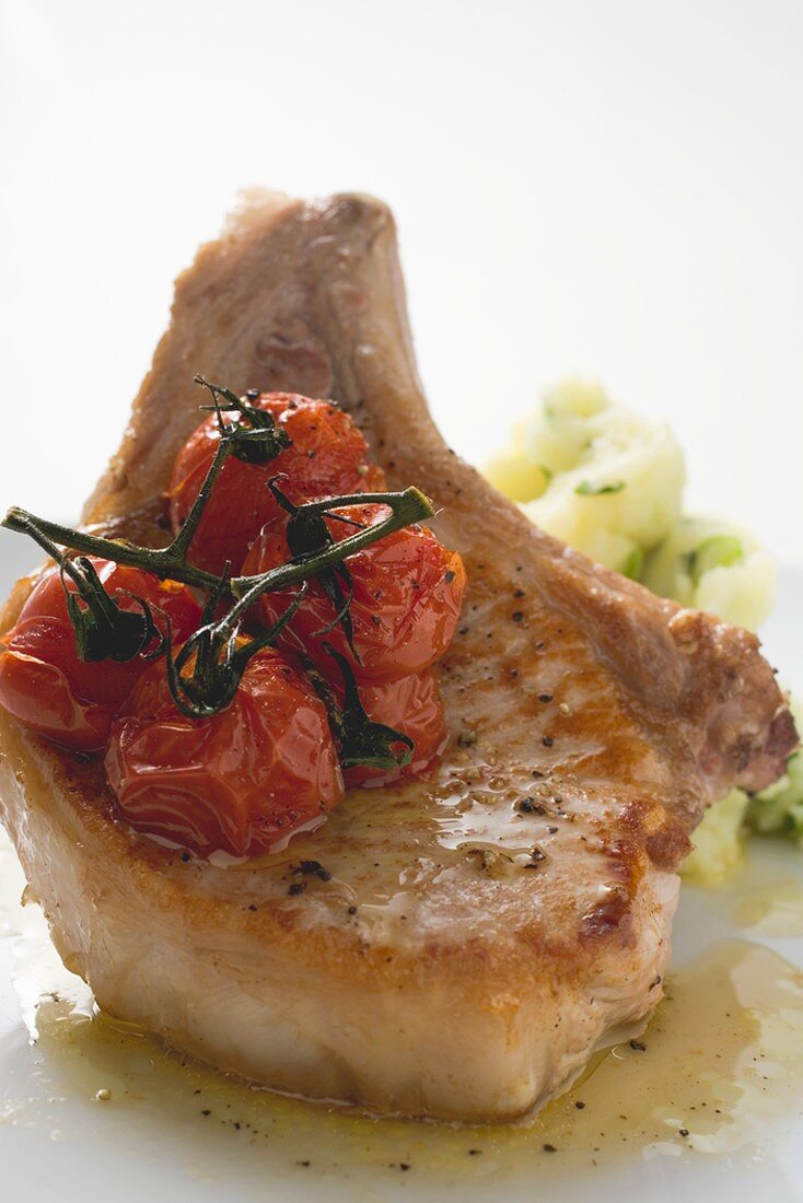 Fried pork chop with cherry tomatoes and mashed potato