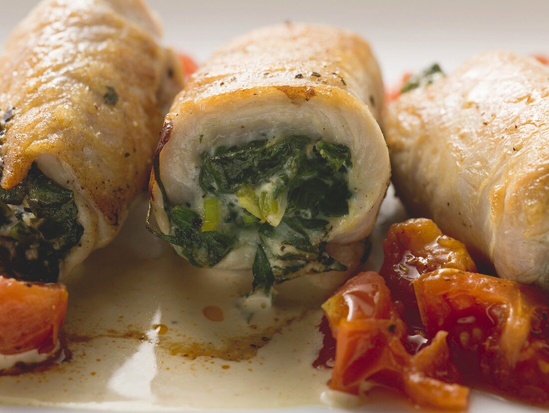 Veal rolls with spinach stuffing and tomatoes